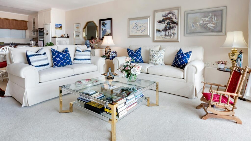 Bright and spotless living room with white furniture and no sign of pests.