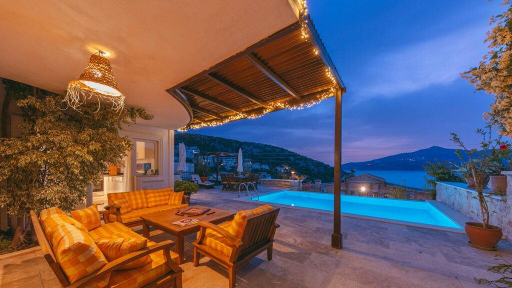 Cozy outdoor patio with warm lighting and scenic pool view, designed to deter insects.