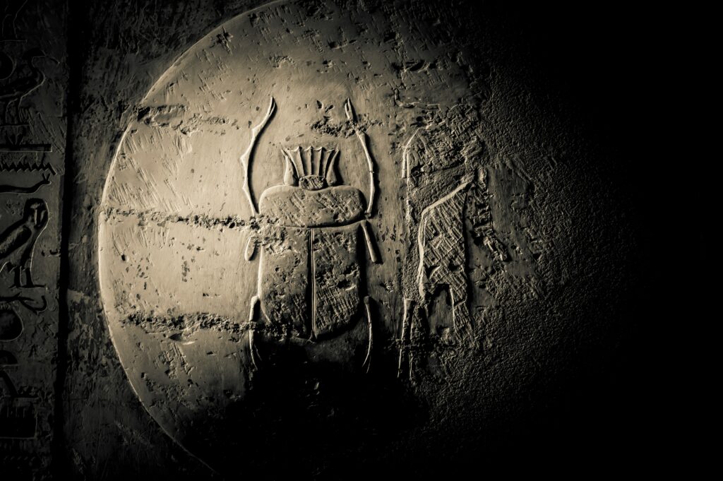 Egyptian scarab amulet carved in stone with hieroglyphics
