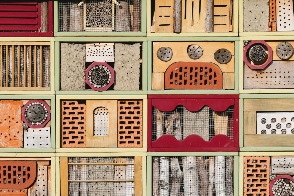 Detailed view of a colorful insect hotel with diverse textures and patterns, promoting biodiversity.