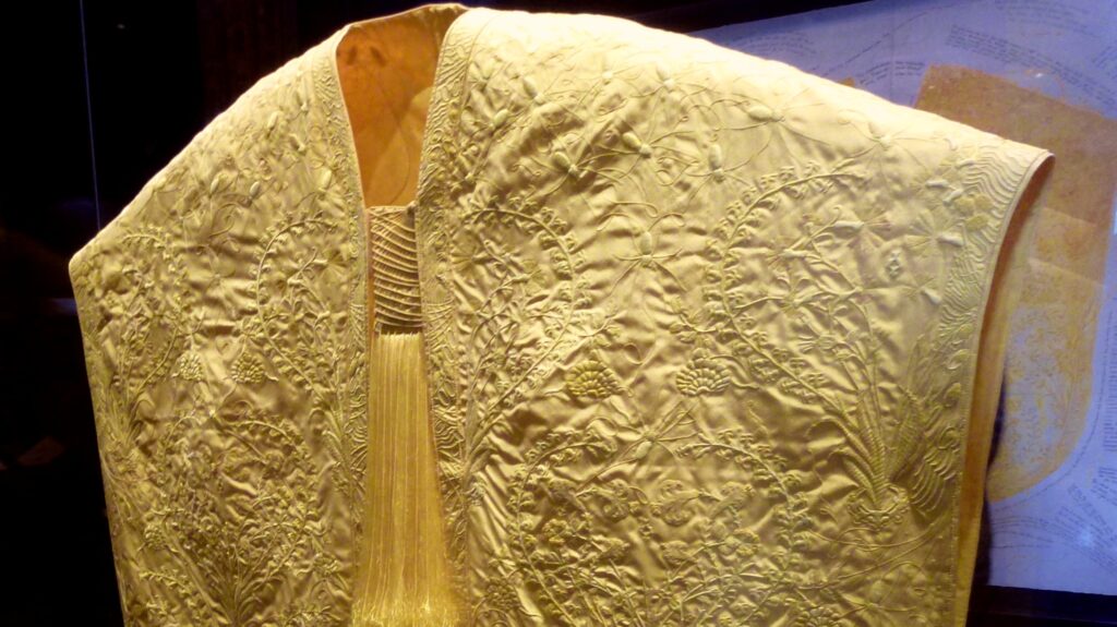 The Golden Spider Silk Cape made by Simon Peers and Nicholas Godley using the silk of over a million golden orb-weaver spiders.