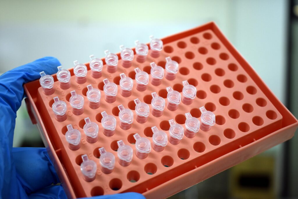 Futuristic lab with scientists analyzing insect DNA on holographic displays