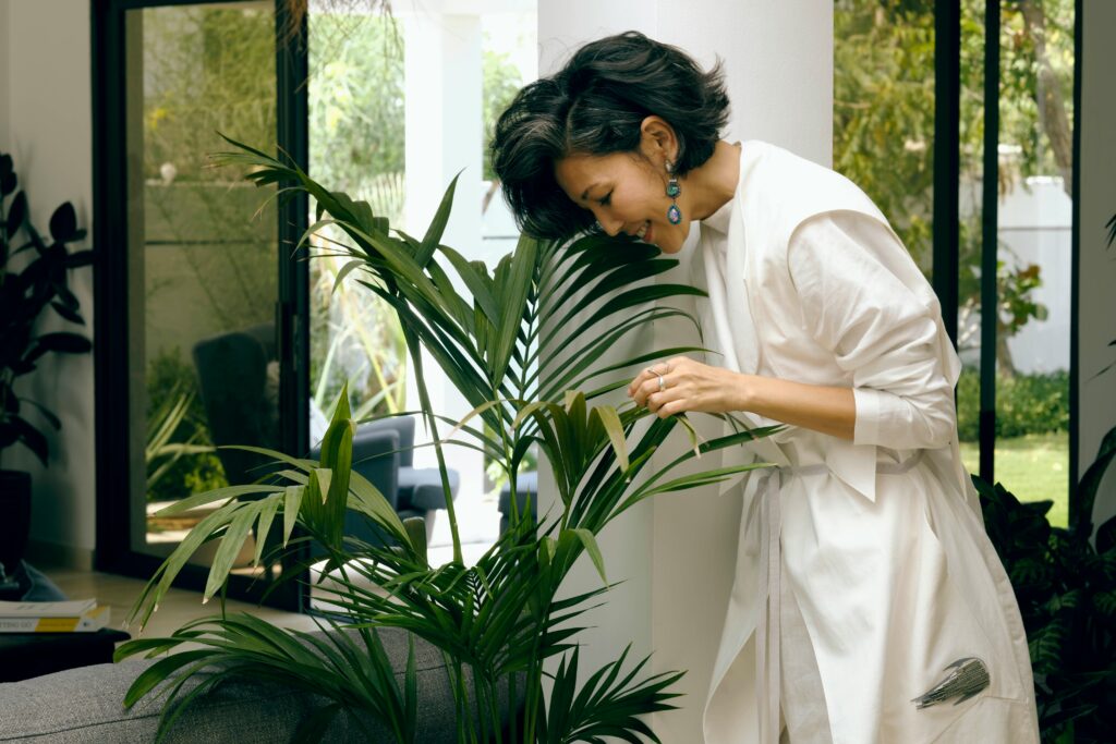 Pest control specialist inspecting indoor plants with magnifier