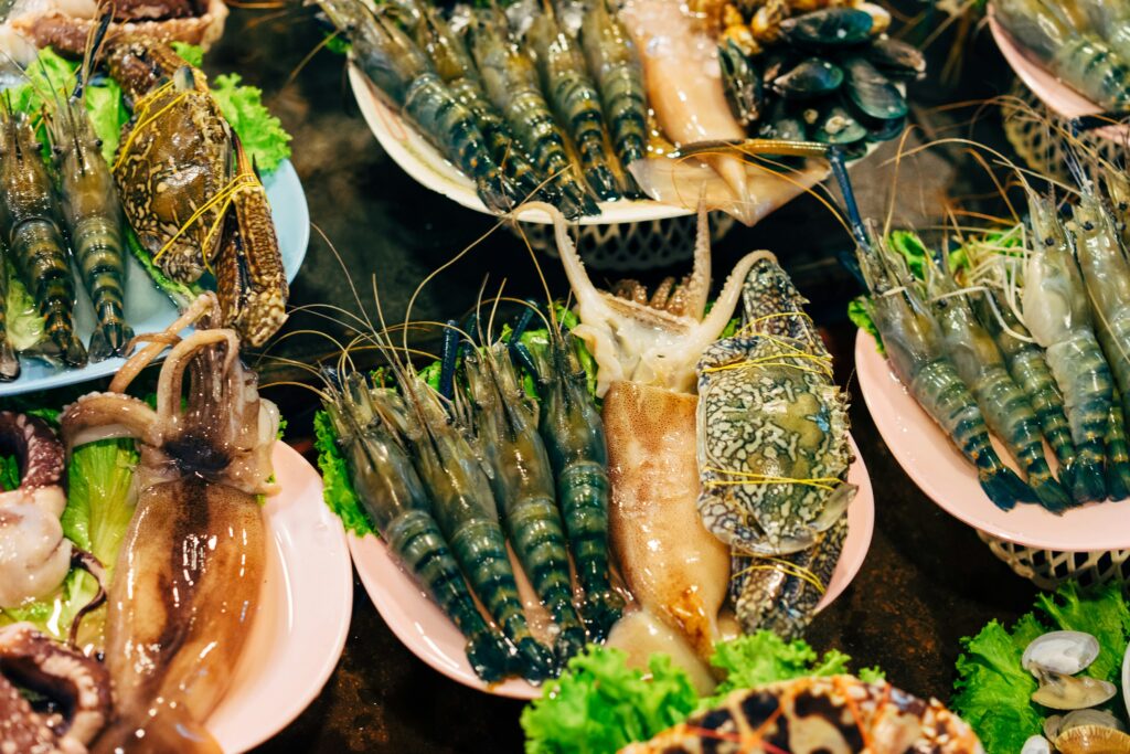Chef plating high-end insect-based cuisine in a fine dining setting