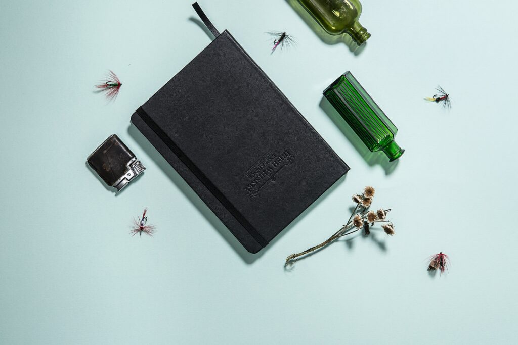 A set of tools including magnifying glass, field notebook, insect net, and containers
