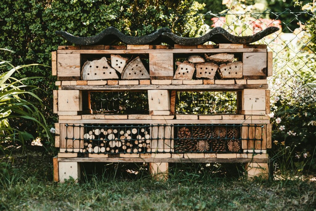 An insect hotel under a tree shade.
