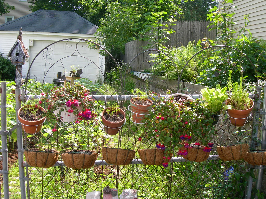 A flower garden with water pots