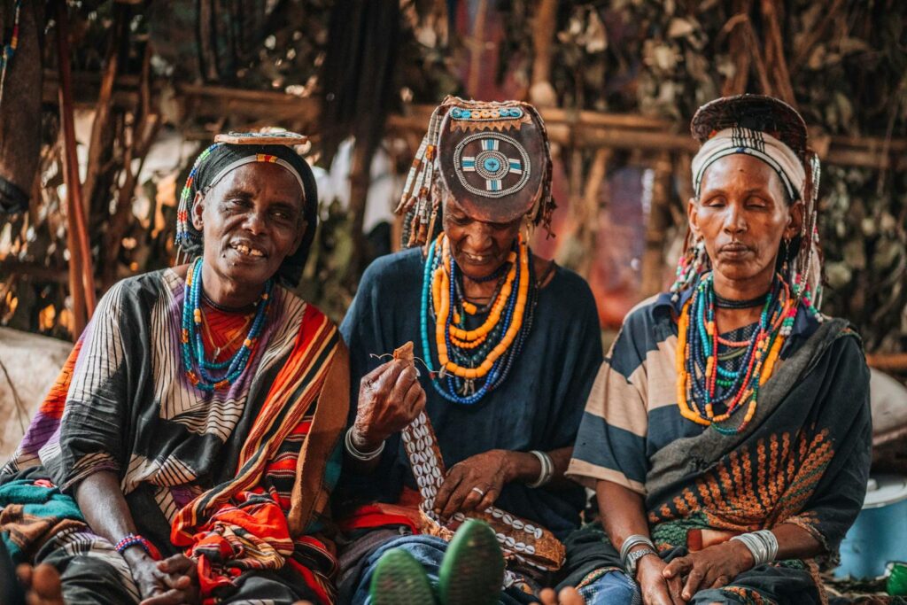 Captivating image of Guji tribe members adorned in traditional clothing and accessories in Oromia, Ethiopia.
