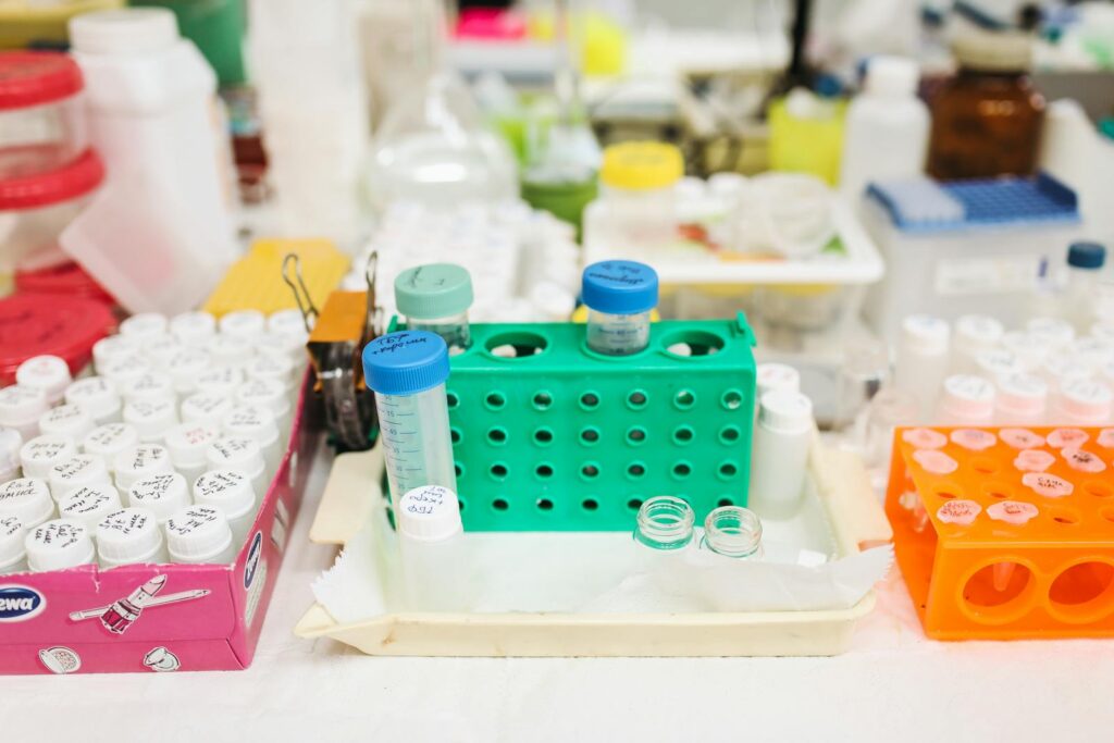 A lab setting, having test tubes and racks.