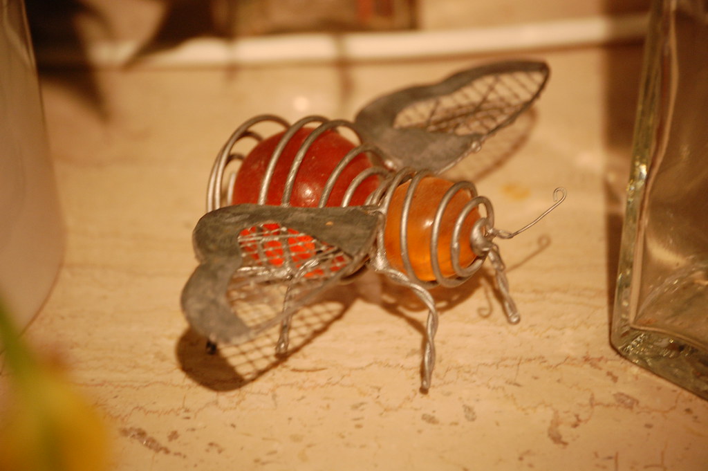 A robotic bee lying on a a brown surface