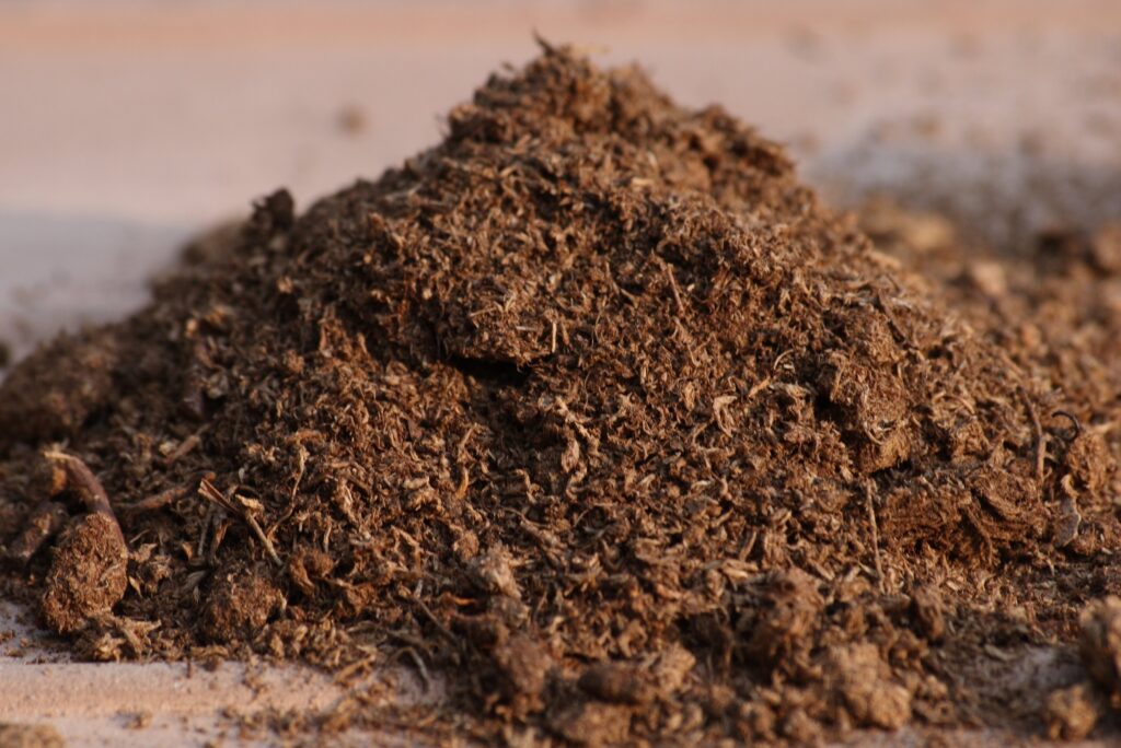 A mound of peat moss on a flat surface.