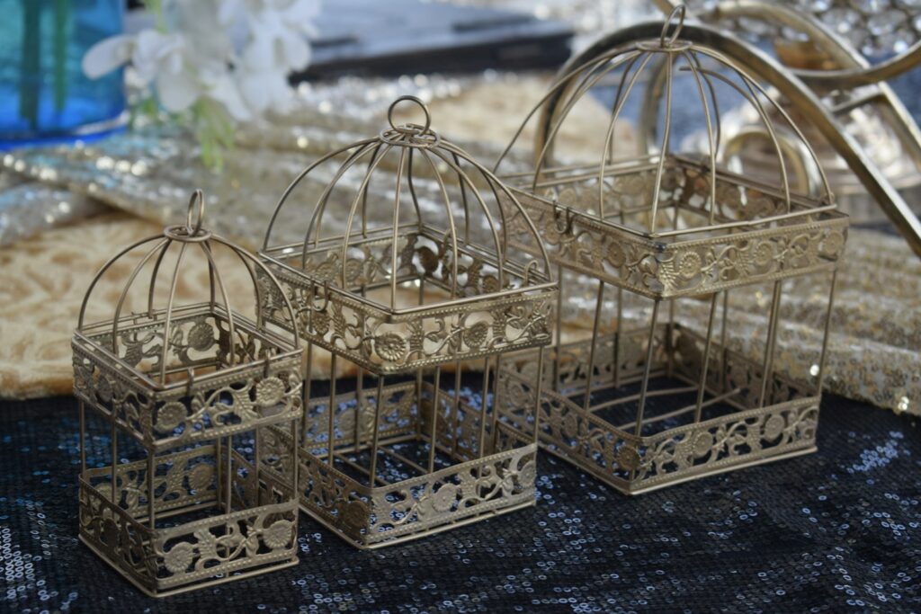 gold metal cage on black textile
