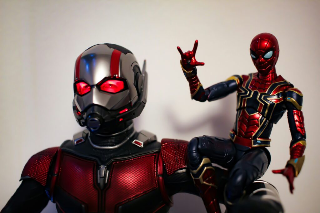 Ant-Man standing beside a real ant, illustrating size reduction concept