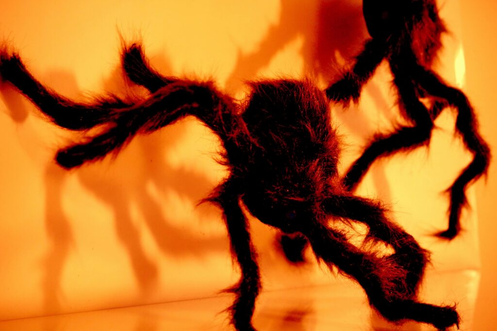 Illustration of Anansi the spider character telling stories to children


