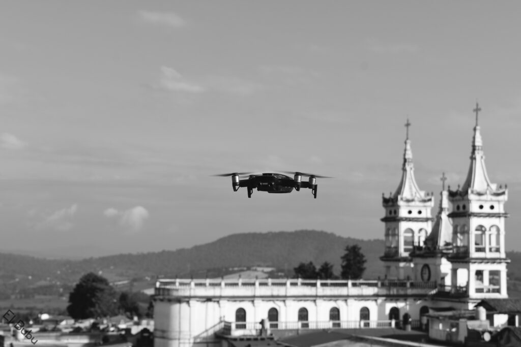 Insect-like drone spying through window, urban environment in background