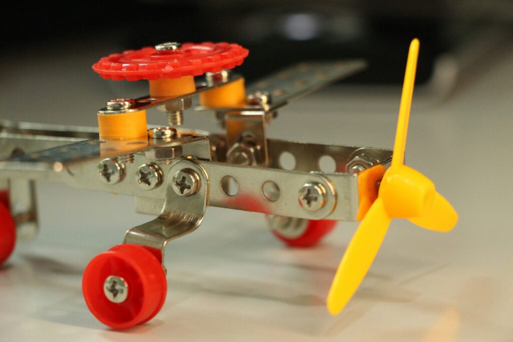 RoboBee prototype hovering midair with blurred wings and Harvard lab background