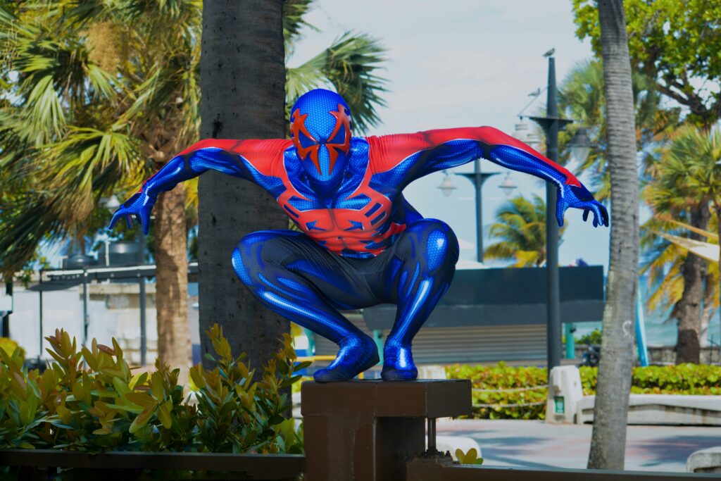 A colorful superhero with butterfly wings flying above flowers