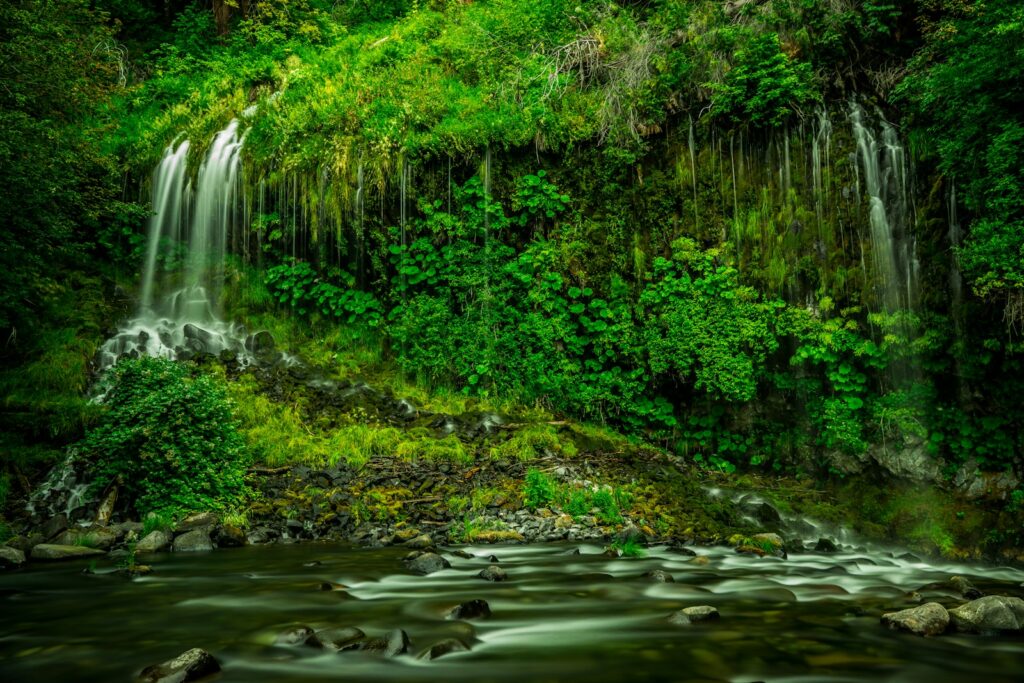 Time lapse photography of multi-step waterfalls in a rainforest