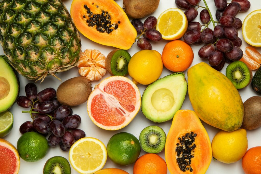 Sliced orange fruit and green round fruits
