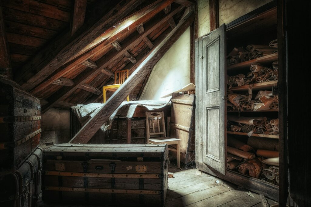 An attic with a bed and a chest of drawers